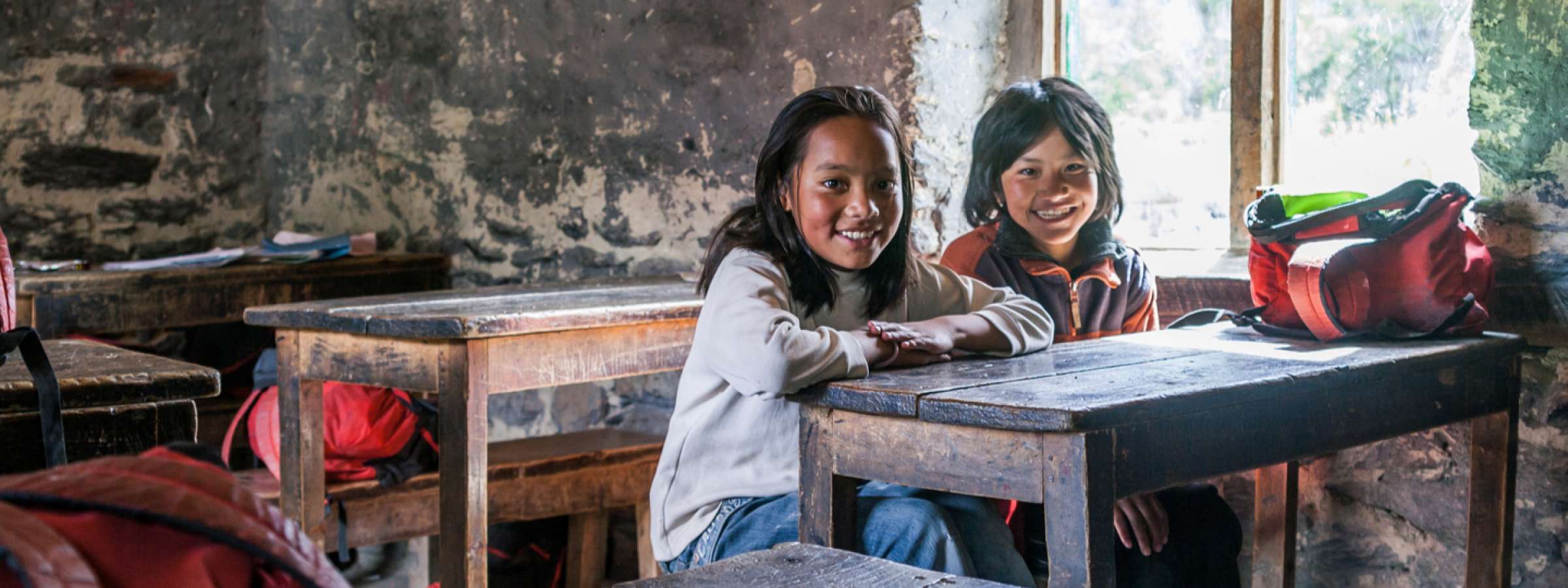 Portrait of two diligent kids looking at camera at workplace.