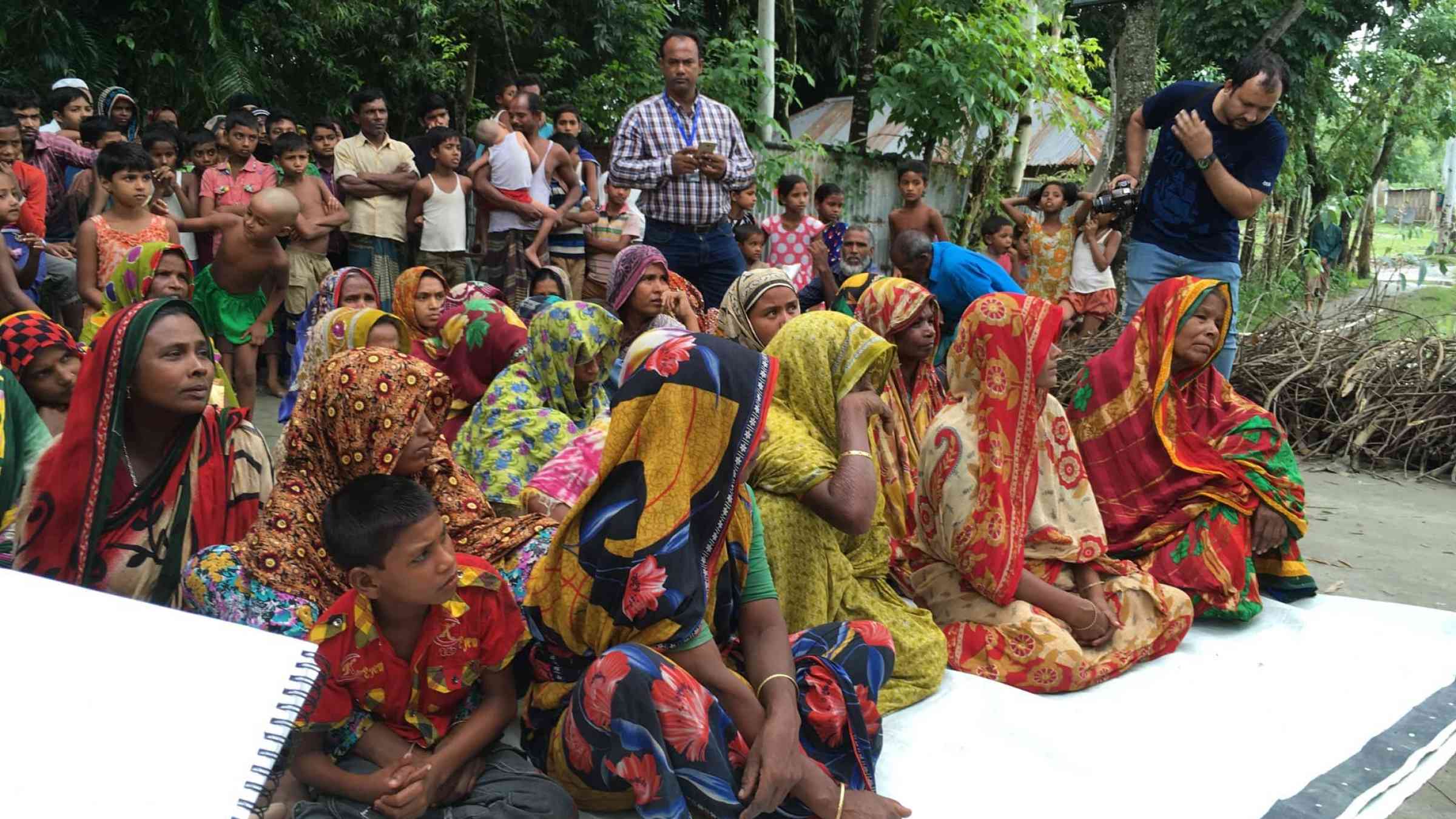 Community members being educated about community resilience and disaster risk reduction