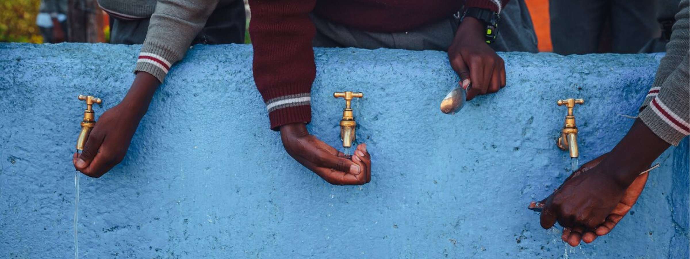 African students using water taps