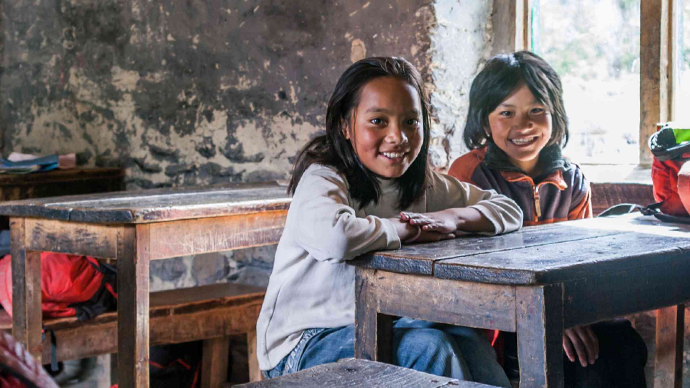 Portrait of two diligent kids looking at camera at workplace.